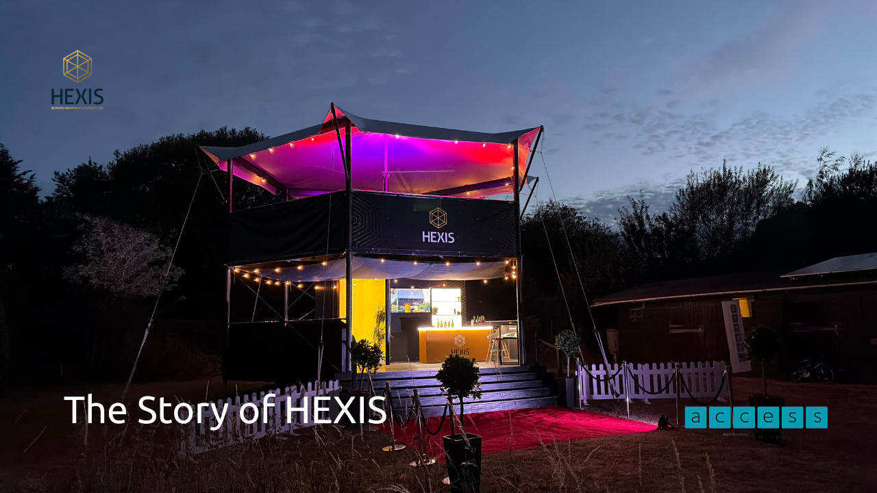 Large, impressive outdoor event structure with lights at night