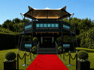 access-exhibition-specialists-branded-structure-red-carpet Access the exhibition specialists branded two-storey structure with red carpet entrance.