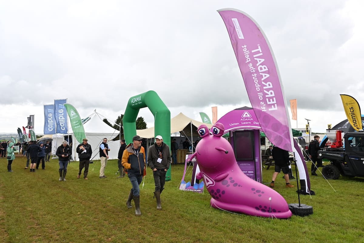 adama-cereals-2026-inflatable-slug-stand ADAMA exhibition stand at Cereals 2026 with giant inflatable slug and green branded arch.