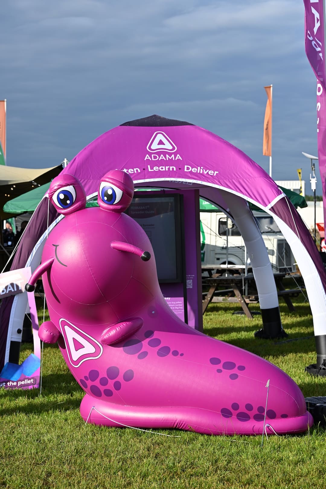 adama-inflatable-slug-mascot-close-up Close-up of the giant purple inflatable slug mascot at the ADAMA stand at Cereals 2026.