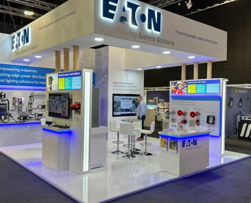 Eaton branded indoor exhibition stand with white display units, LED lighting and product wall