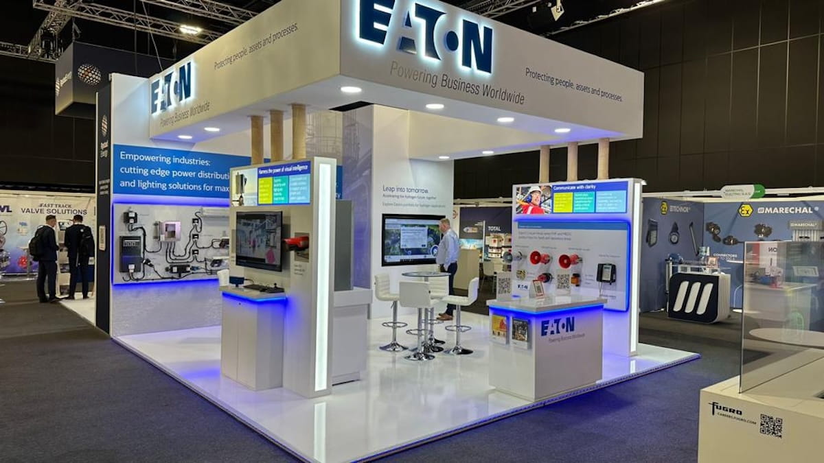 eaton-indoor-exhibition-stand-white-branded-design Eaton branded indoor exhibition stand with white display units, LED lighting and product wall