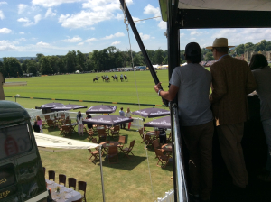guests-watching-polo-match-from-hospitality-balcony Guests watching a polo match from a hospitality structure balcony overlooking Jaeger-LeCoultre branded pitch-side seating