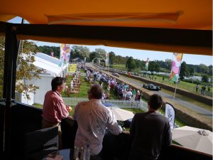 View from a HEXIS Sky Lounge upper deck overlooking a live motorsport event and hospitality area