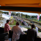 View from a HEXIS Sky Lounge upper deck overlooking a live motorsport event and hospitality area