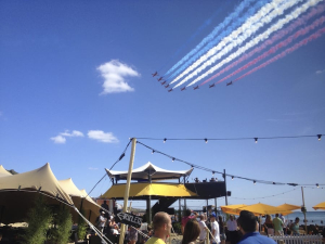 HEXIS Sky Lounge hospitality structure at an outdoor event with aerial display viewing