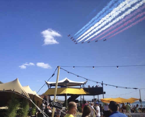 HEXIS Sky Lounge hospitality structure at an outdoor event with aerial display viewing