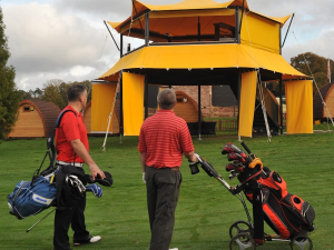 HEXIS Sky Lounge hospitality structure overlooking a golf event with elevated viewing area and guest hospitality space