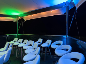 hexis-upper-deck-seating-coloured-lighting-night HEXIS upper deck seating area with white stools and blue and green ambient lighting at night