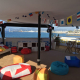 Interior of a HEXIS VIP hospitality lounge overlooking a marina with seating, tables and branded event decor
