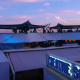 HEXIS rooftop hospitality venue at sunset with festoon lighting, marquee canopies and guests gathered on the terrace