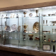 Long wooden glass display cabinet at Slough Borough Council showcasing silver trophies, awards and finalist certificates