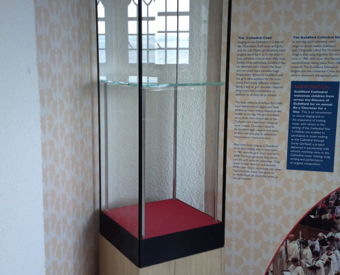 tall-glass-display-case-guildford-cathedral Tall glass display case with oak base and red interior at Guildford Cathedral